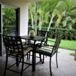 There is a lush tropical garden view from the lanai